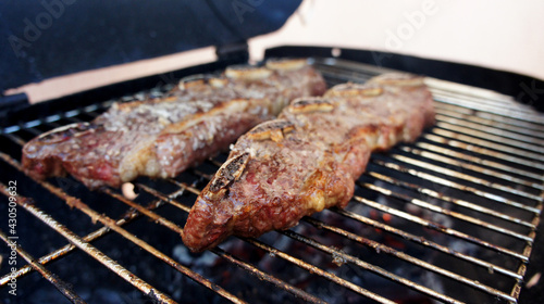 Assado de Tira or Strip roast. Traditional beef rib cut for a delicious barbecue on wooden background