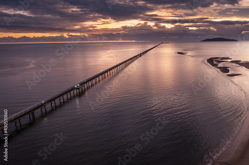 Sunrise view of the famous 6km long sugar cane jetty at Lucinda in Far North Queensland, Australia photo