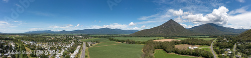 Aerial panoramic view of Walsh's Pyramid mountain and sugar cane fields surrounding the town of Gordonvale in Queensland Australia photo