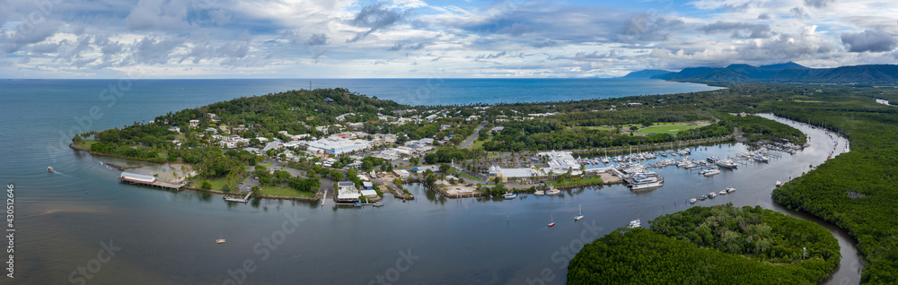 Dramatic aerial panoramic views of the beautiful town and marina of Port Douglas, a popular tourist destination in Far North Queensland Australia
