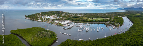 Dramatic aerial panoramic views of the beautiful town and marina of Port Douglas, a popular tourist destination in Far North Queensland Australia