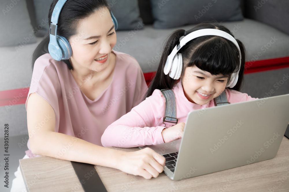 Very happy child playing game online with laptop stay at home. Asian boy  student online learning class study online video call teacher Stock Photo -  Alamy