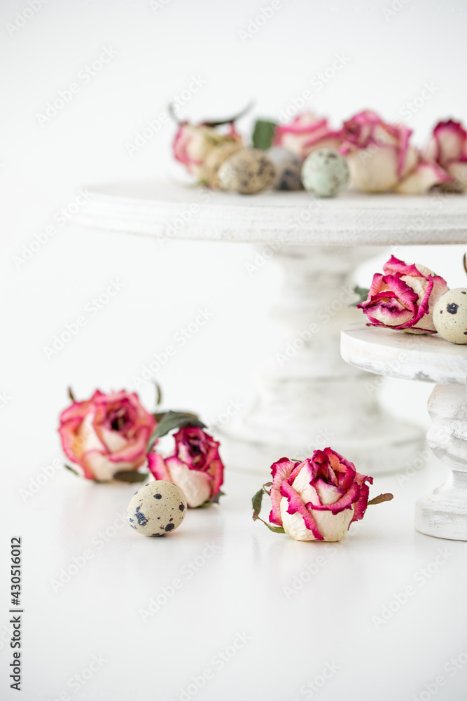 Still life with roses. Quail eggs on a wooden stand. Rustic. Easter celebration concept. Still life with roses. Quail eggs on a wooden stand. Rustic. Easter celebration concept.