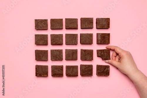 Fotografie Woman hand grabbing a piece of fudge