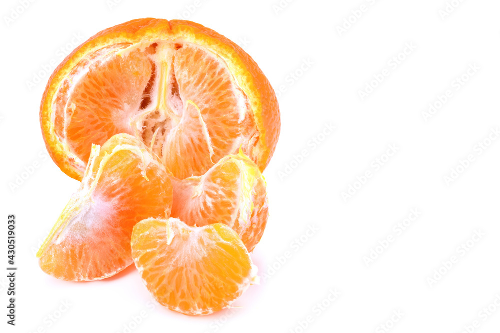 Half a tangerine and slices isolated on a white background. Half a tangerine and slices isolated on a white background.