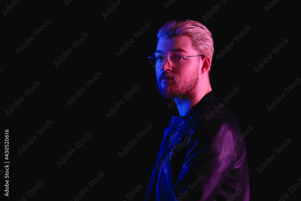 Toned portrait of handsome young man on dark background Toned portrait of handsome young man on dark background