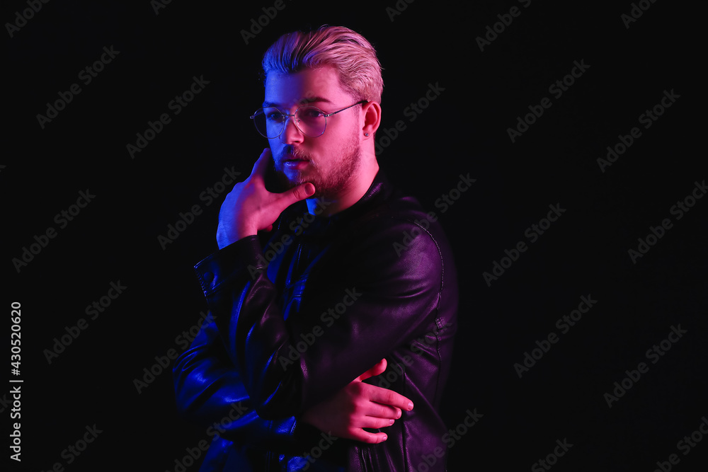 Toned portrait of handsome young man on dark background Toned portrait of handsome young man on dark background