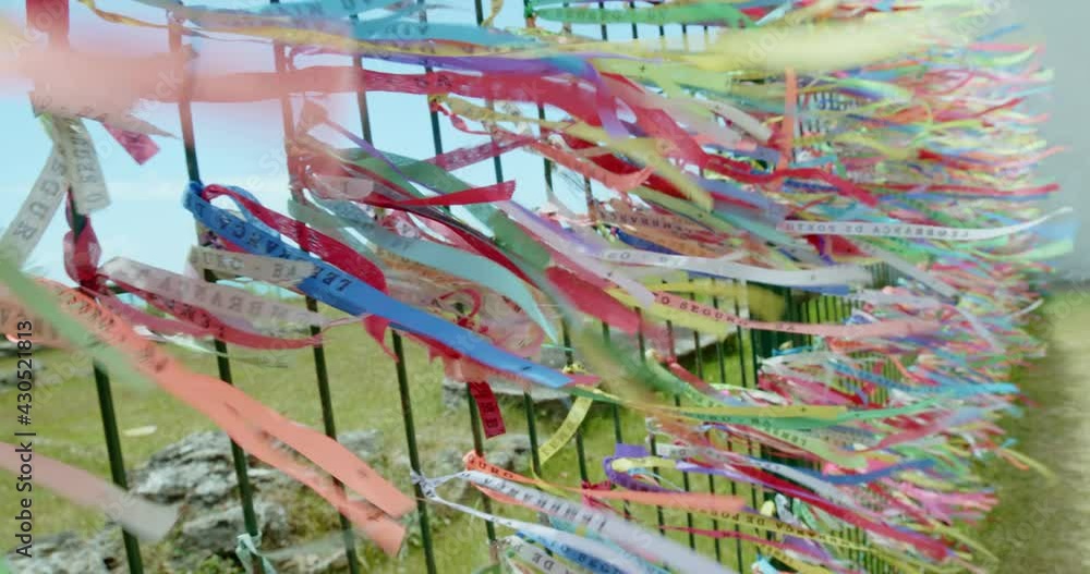 Closeup of colorful ribbons in Bahia, Brazil. Man hand making an request with Brazilian ribbons. Faith. 6K. Closeup of colorful ribbons in Bahia, Brazil. Man hand making an request with Brazilian ribbons. Faith. 6K.