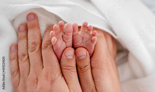 Newborn feet in mother hands