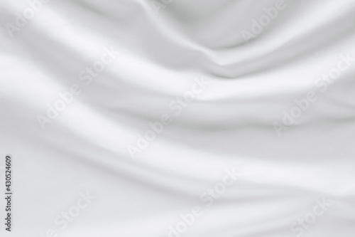 Abstract white fabric texture background. Cloth soft wave. Creases of satin, silk, and cotton.