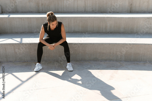 Young athletic woman and her shadow during summer workout