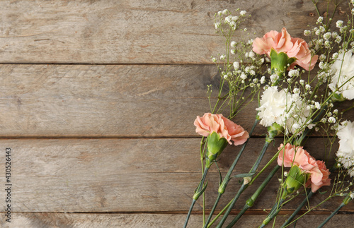 Fototapeta Naklejka Na Ścianę i Meble -  Fresh carnation flowers on wooden background