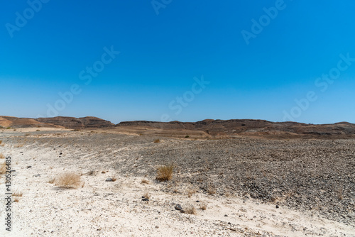 A view from the crater in the Ramon Crater. Arid desert view. White sands and a horizon of blue skies. Negev  Israel. High quality photo
