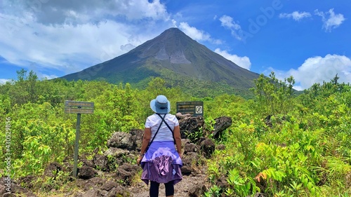 Woman hiking in front Arenal Volcano Costa Rica, La Fortuna Quarantine End pura vida photo