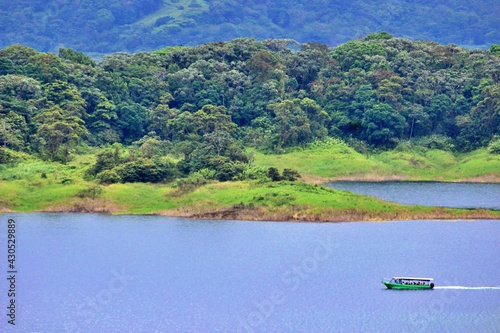 Scenic drone view of tourist boat in Arenal lake La Fortuna, Costa Rica. Quarantine End