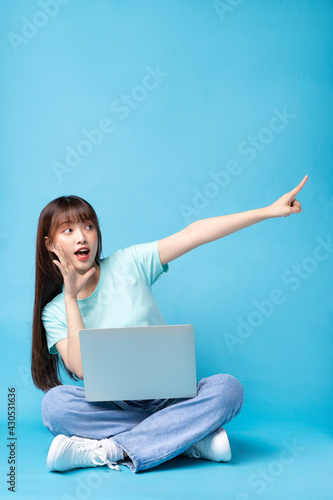 Image of young Asian girl on blue background © Timeimage