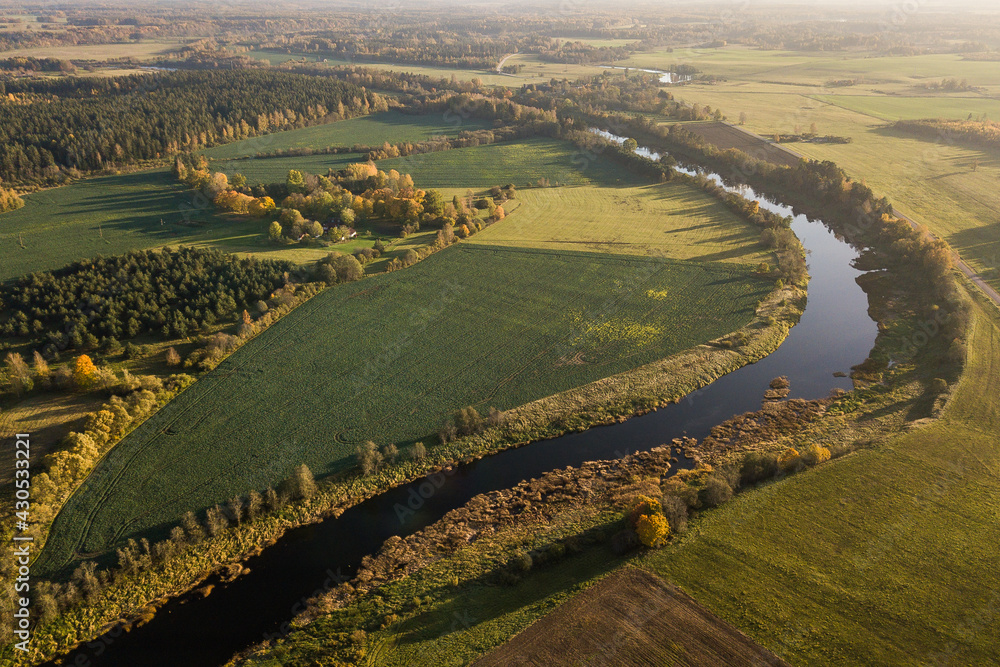 Aerial view of river Venta in sunny autumn evening, Latvia.