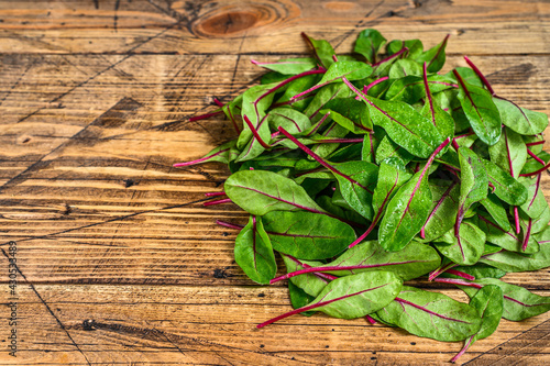Fresh raw chard leaves, mangold, swiss chard on a wooden kitchen table. Wooden background. Top view. Copy space