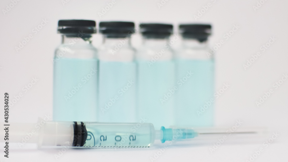 Medical ampoules and insulin syringe isolated on white background, vaccination concept Medical ampoules and insulin syringe isolated on white background, vaccination concept