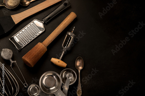 Set of kitchen utensils on black background. Tools for cooking.