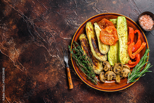 Grilled mix vegetables in a rustic plate. Dark background. Top view. Copy space