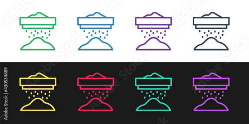 Set line Sifting flour, cereals or powdered sugar through sieve icon isolated on black and white background. Vector