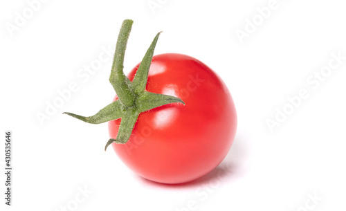 Close up of a cherry tomato with leaf isolated