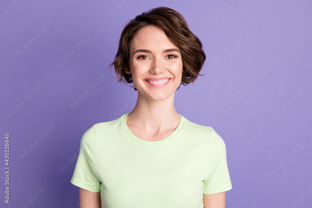 Portrait of attractive cheerful glad brown-haired teen girl wear white tshirt isolated over violet color background