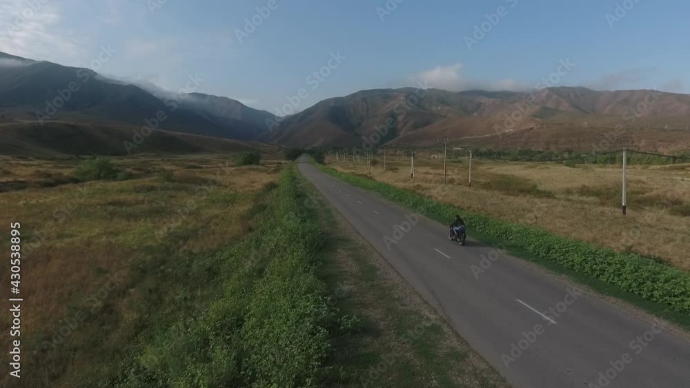 Guy with a girl on a motorcycle. man and woman driving motorbike on cloudy day Guy with a girl on a motorcycle. man and woman driving motorbike on cloudy day