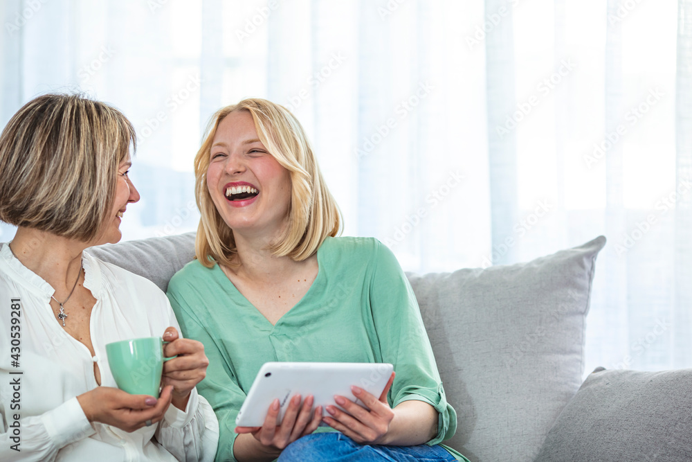 Young woman and mother spending time together at home. Cute young daughter embracing her mother with love. Happy loving older mature mother and grown millennial daughter laughing embracing Young woman and mother spending time together at home. Cute young daughter embracing her mother with love. Happy loving older mature mother and grown millennial daughter laughing embracing