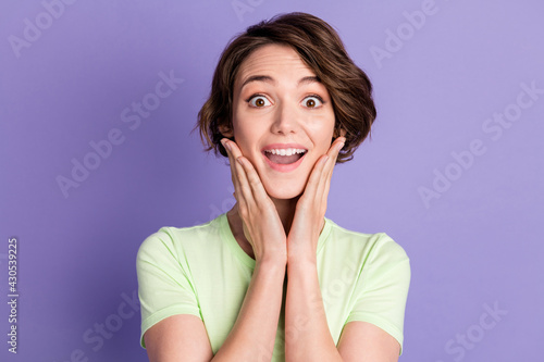 Close-up portrait of nice attractive amazed cheerful girl good news reaction isolated over bright violet purple color background