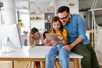 Online school, technology, family concept. Happy parents helping to children to study at home