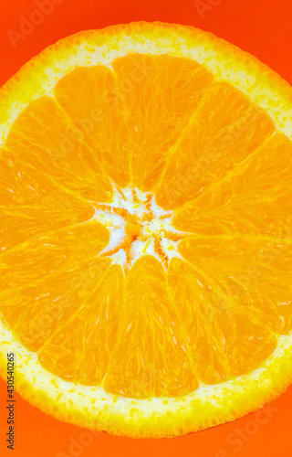 Orange fruit on orange background. Minimalism, original beautiful photo. Vertical wallpaper for smartphone. 