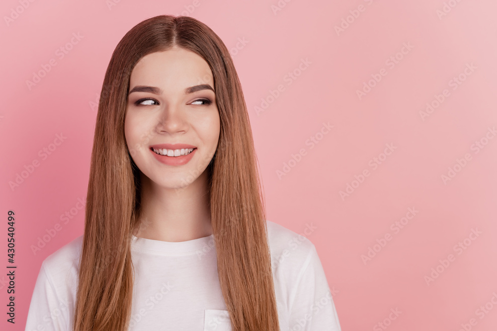 Portrait of positive adorable cute lady look side empty space beaming smile on pink wall Portrait of positive adorable cute lady look side empty space beaming smile on pink wall