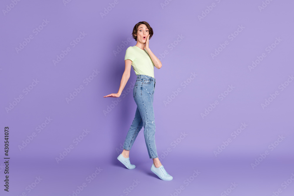 Full length body size profile side view of lovely amazed girl jumping going pout lips isolated over violet color background Full length body size profile side view of lovely amazed girl jumping going pout lips isolated over violet color background