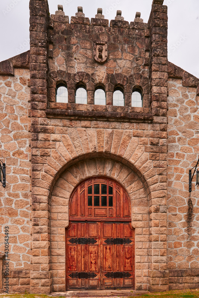 large wooden door in stone building. castle or fortress gate