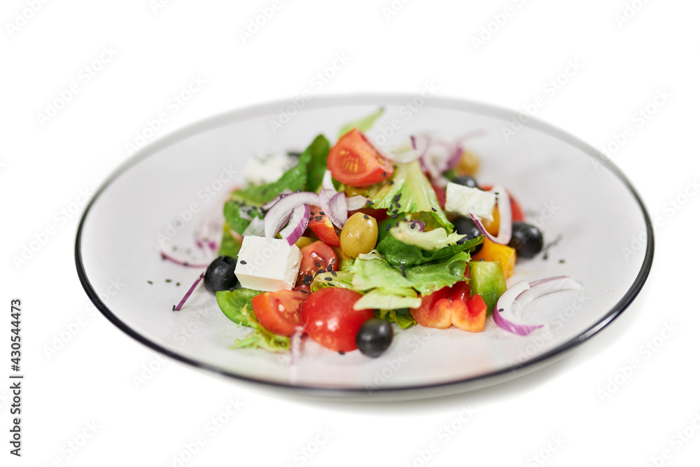 Close up of salad with tomatoes,olives, feta cheese, onion and fresh greens in white background. Concept of delicious vegetables with healthy ingredients for weight loss. Close up of salad with tomatoes,olives, feta cheese, onion and fresh greens in white background. Concept of delicious vegetables with healthy ingredients for weight loss.