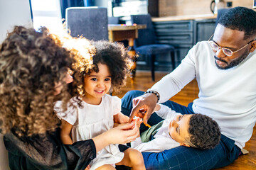 multicultural hispanic family wearing rabbit ears in living room soft sun day light