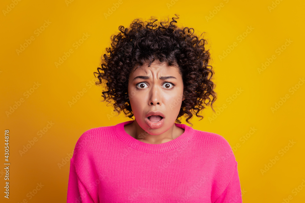 Portrait of negative nervous sad girl open mouth look camera on yellow wall Portrait of negative nervous sad girl open mouth look camera on yellow wall