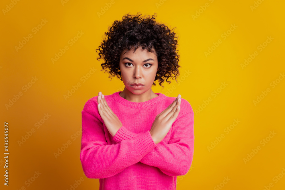 Portrait of confident girl cross hands on chest stop sign on yellow wall Portrait of confident girl cross hands on chest stop sign on yellow wall