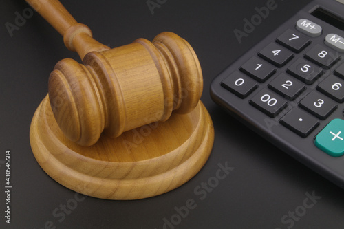 Arbitration concept with wooden judge gavel and calculator