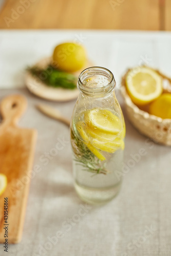 Glass bottle detox healthy water with lemon and rosemary
