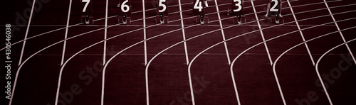 Starting blocks in track and field. Professional sport concept. Red color filter