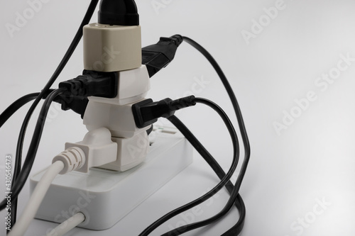 Multiple power socket with connected plugs , Multi plug electrical power strip on a white background , Unsafety concept photo