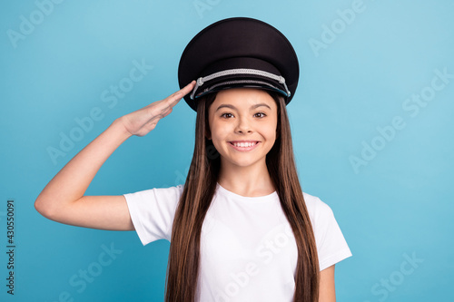 Portrait of attractive cheerful content ambitious girl wearing hat posing isolated over bright blue color background