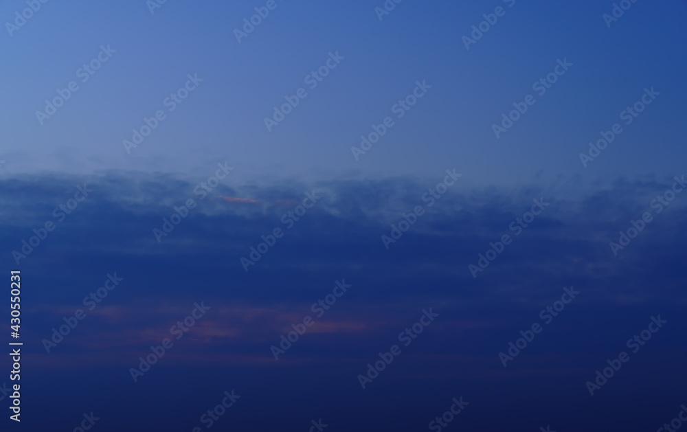 beautiful sunset sky, twilight, dark silhouette of clouds as a background