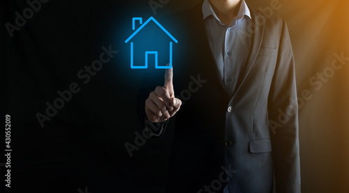 Real estate concept, businessman holding a house icon.House on Hand.Property insurance and security concept. Protecting gesture of man and symbol of house.