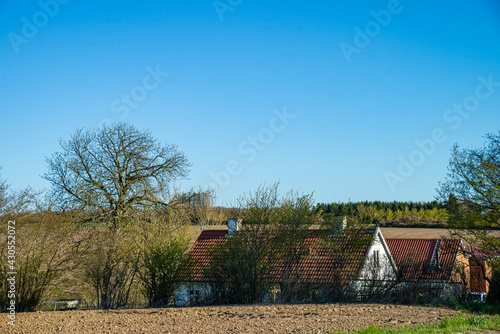 Fotografie Byen Odder 23-04-2021 - An old thatched house, A modern lat car approaching, and a wine mill in the background