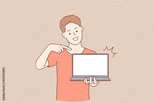 Distance and e-learning education concept. Young smiling man student cartoon character standing pointing at white blank laptop vector illustration 