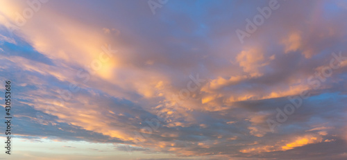 Panorama photo of pink clouds on dramatic sky at sunset